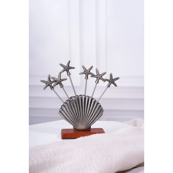 this is an image by the empty space that deals in premium home decor items online in India. The is an image of barware product of the empty spaces. The product is sea shell appetizer pick set which is made in India.