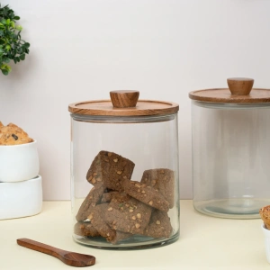 this is an image by the empty space that deals in premium home décor items online in India. The is an image of food storage kitchenware product of the empty spaces. The product is glass jar with wooden lid which is made in India.